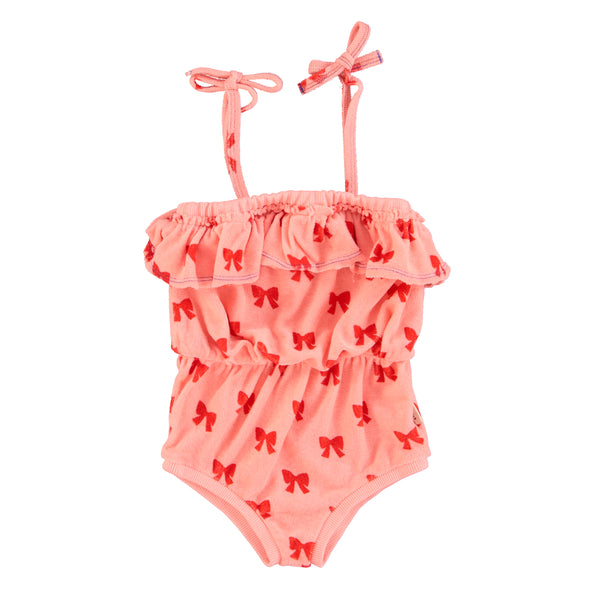 Tuta in spugna rosa con fiocchi rossi per neonata